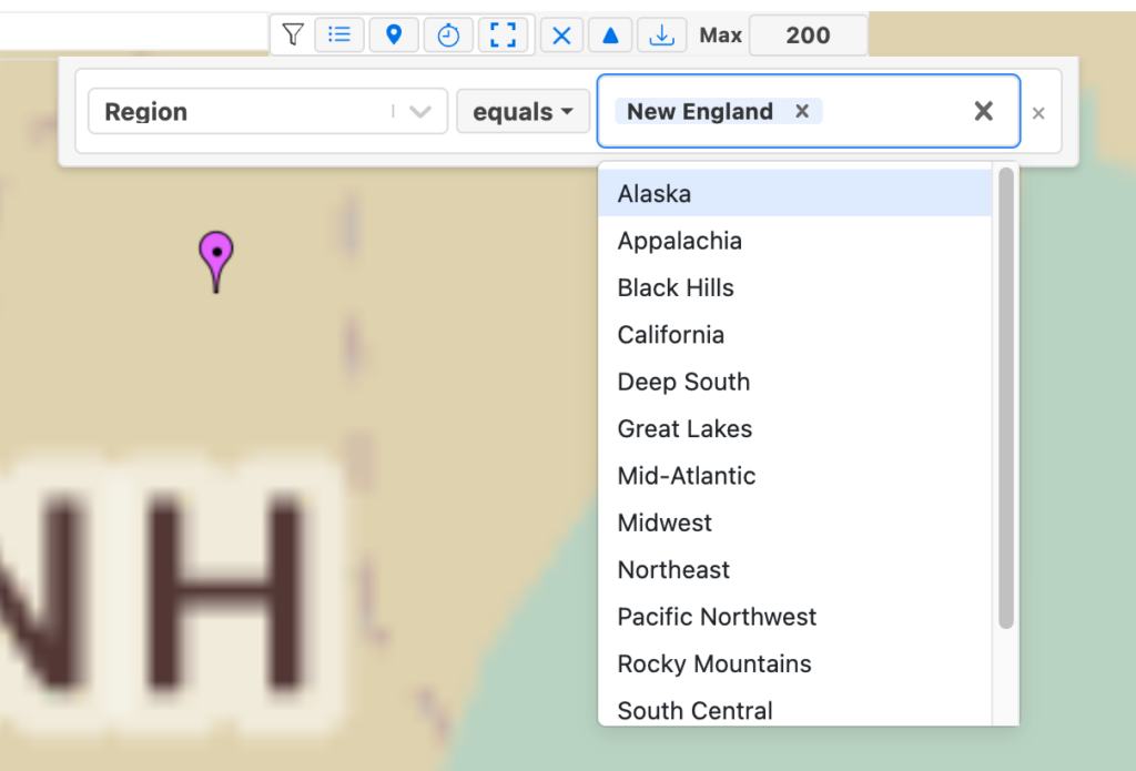 A ZeeMaps field filter chip set to Region equals New England, with the value picker open listing the other regions on the map